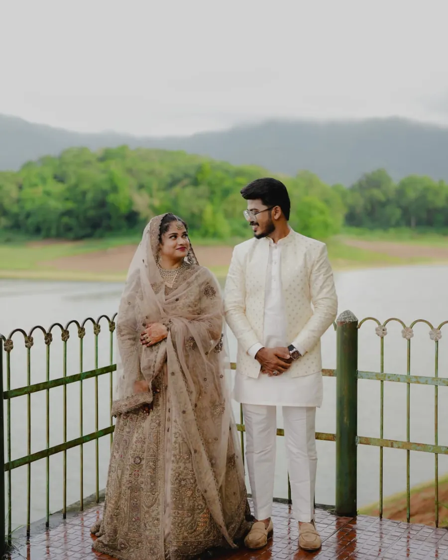 Anfas and Sumiya in wedding attire beside a lakeside garden